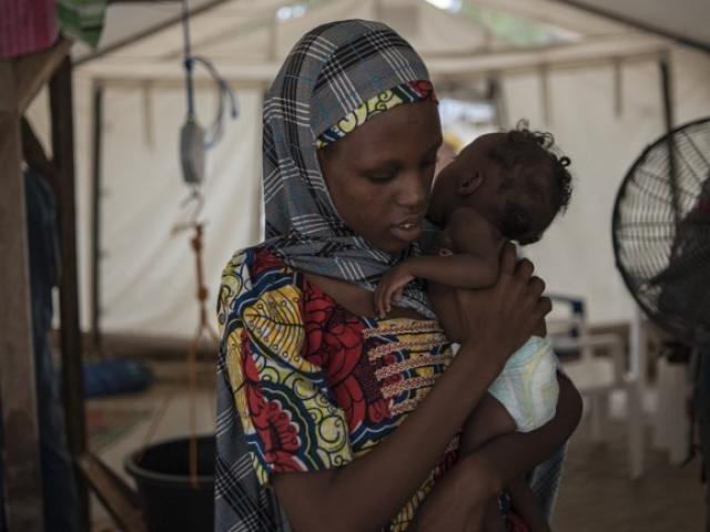 A woman holds her baby during a check-up at the in-patient therapeutic feeding centre in Maiduguri, the capital of Nigeria's Borno state, in September 2016. Photo: STEFAN HEUNIS/AFP