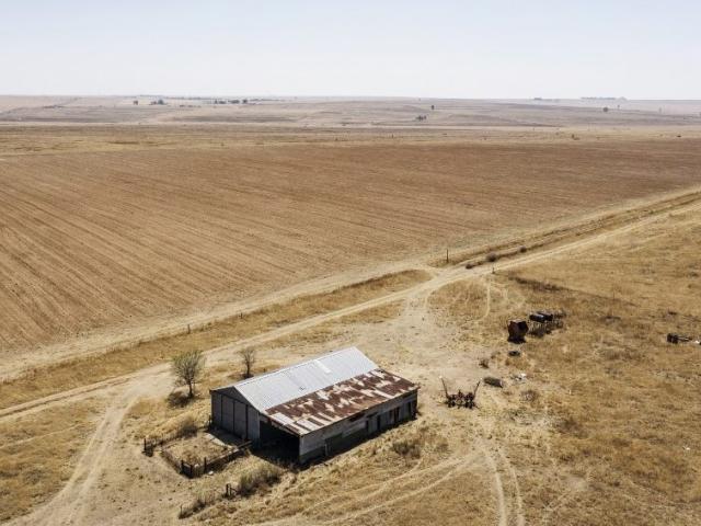 Vacant farm land with large barn 
